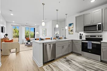 A modern kitchen with a large island and stainless steel appliances.